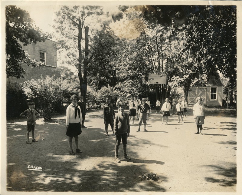 In front of little house (kindergarten bldg?)